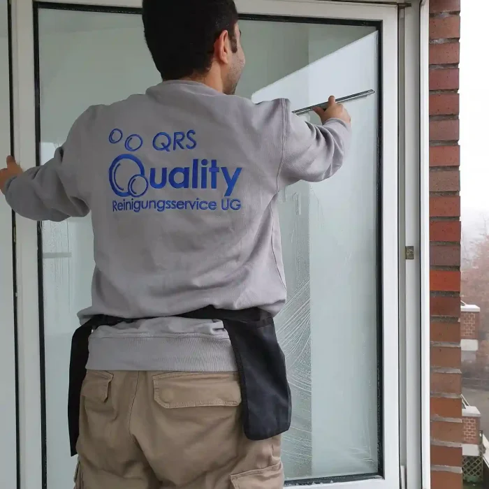 Quality Reinigungsservice Mitarbeiter putzt ein Fenster